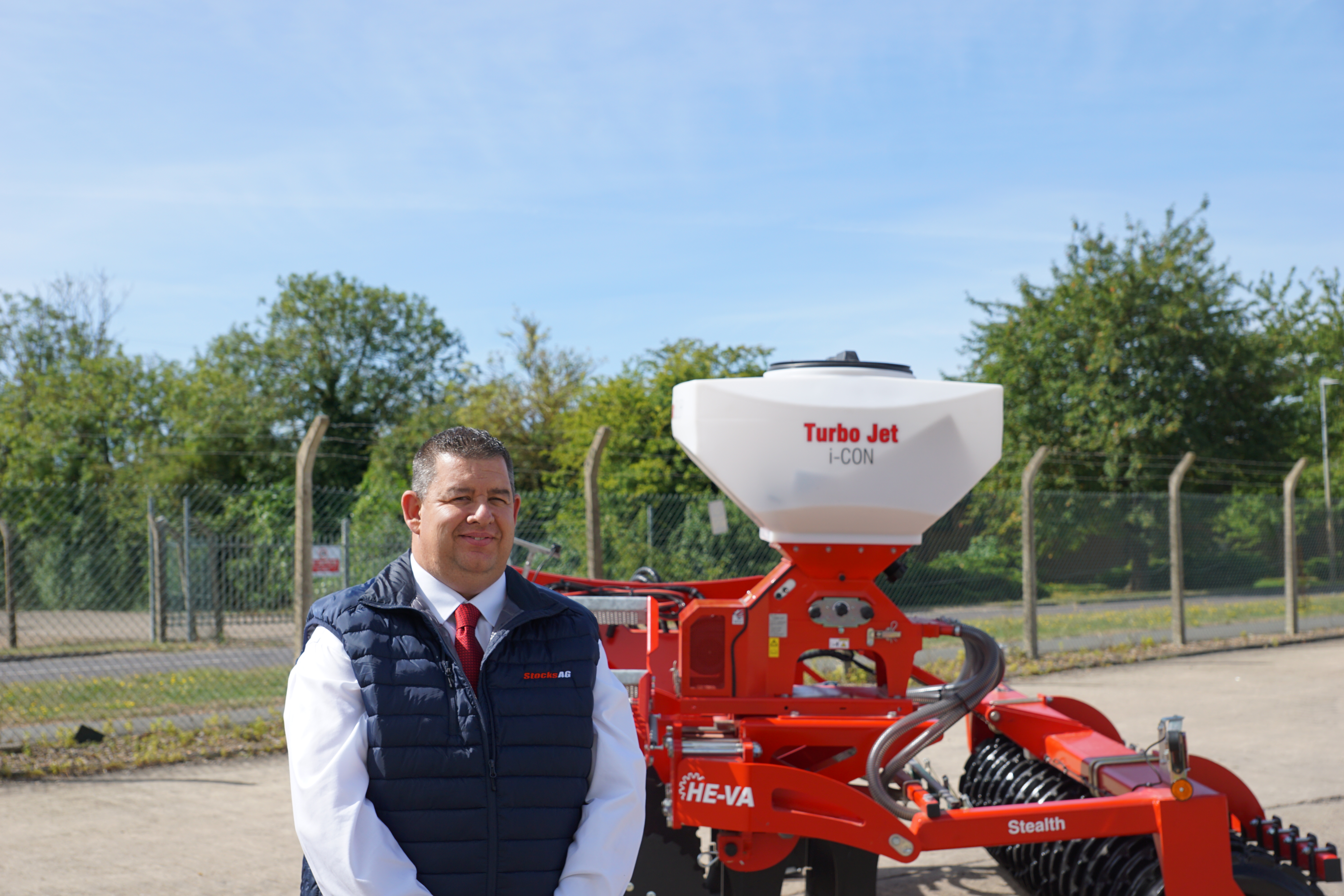 Sean Stanfield, Stocks Ag Sales Manager stood with a Stocks Ag Turbo Jet 240L applicator