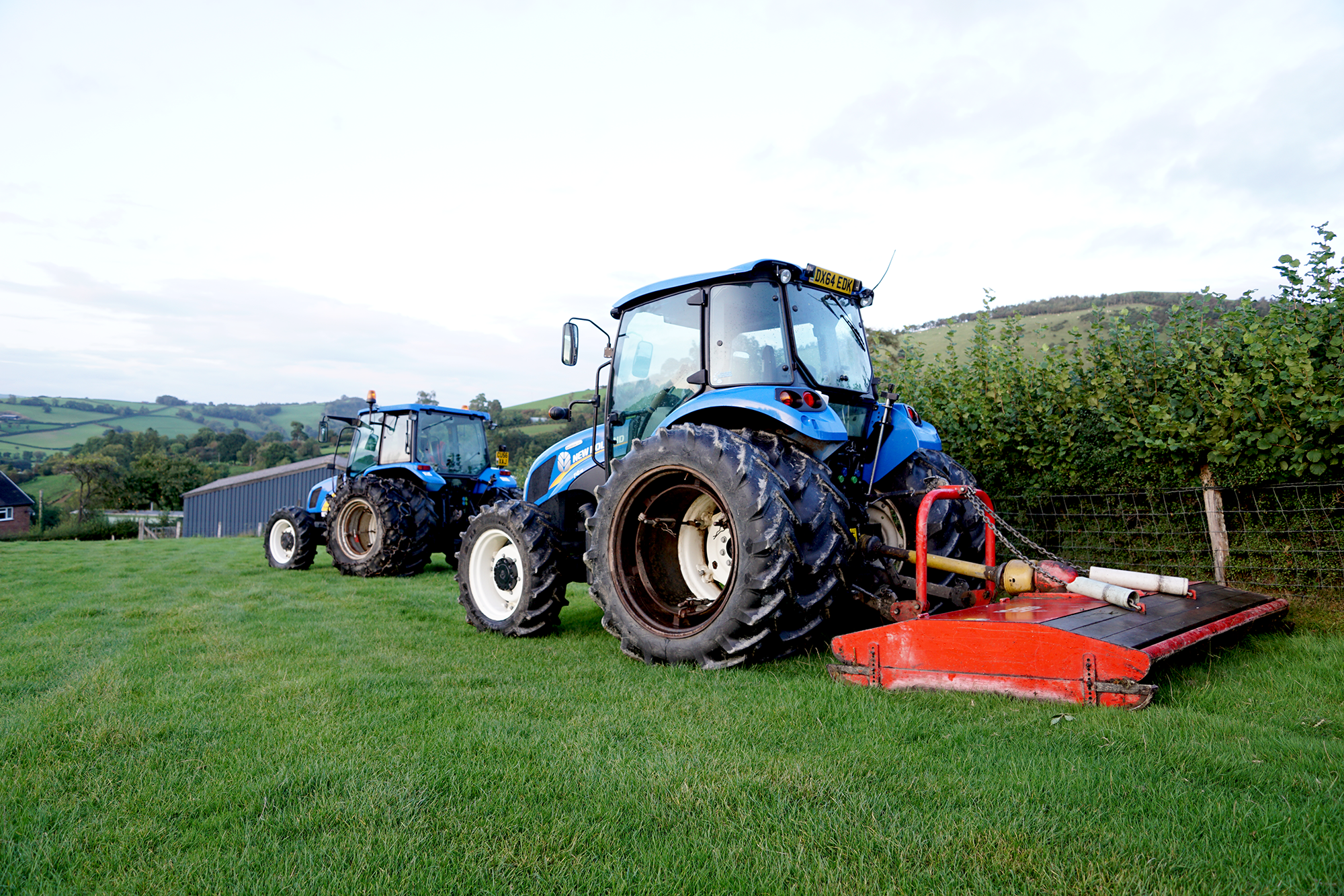 Two New Holland tractors in field fitted with Stocks Ag Dual Wheels