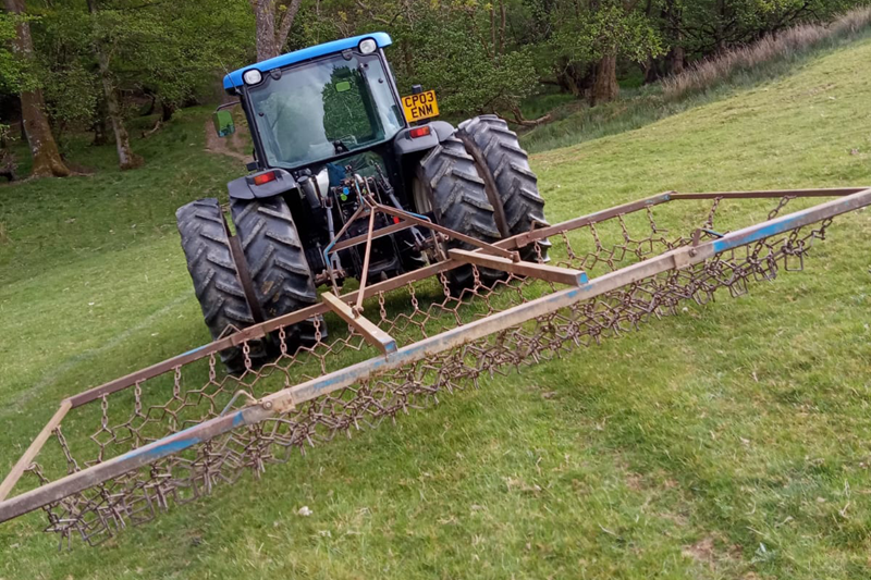 New Holland tractor chain harrowing slopes, fitted with Stocks Ag Dual Wheels