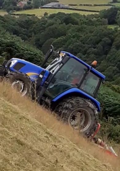 New Holand tractor fitted with Stocks Ag Dual Wheels topping steep land in mid Wales